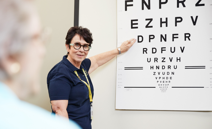 Vision Australia clinician points to an eye chart