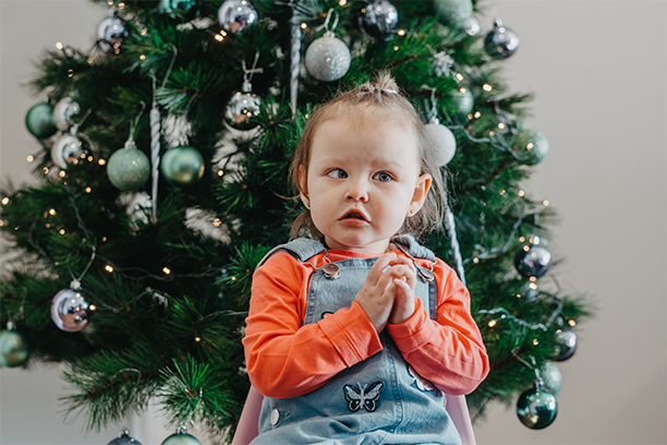 Luna in front of her Christmas tree