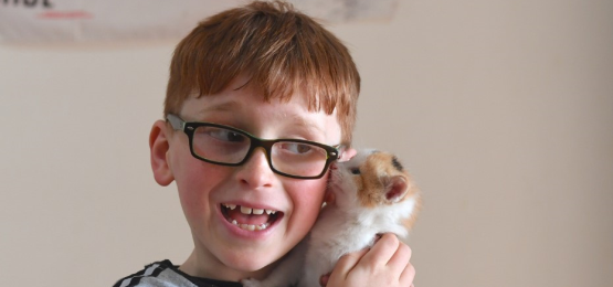 Zavier joyfully holding a kitten