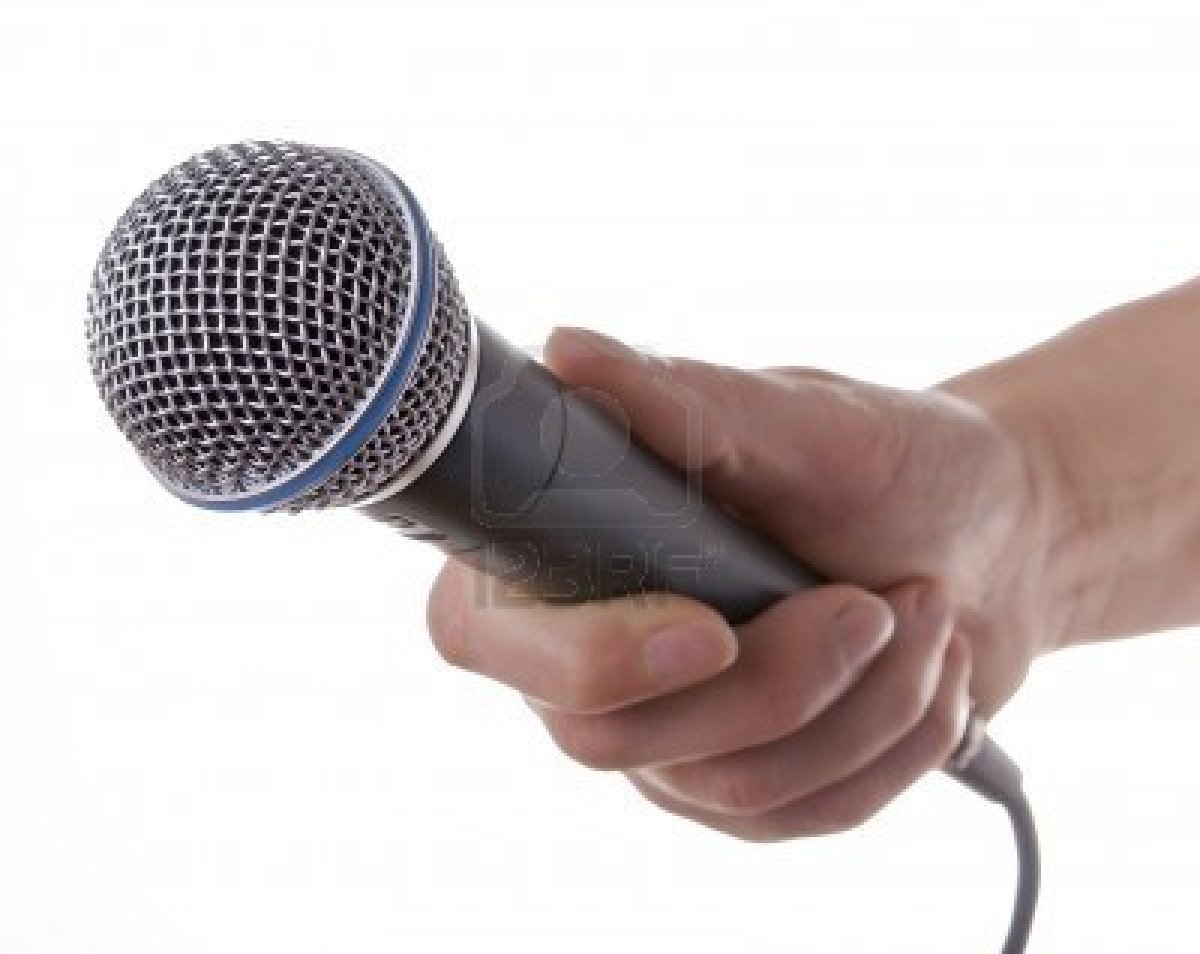 Hand holding a microphone out for someone to speak into