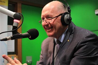H.E. Governor General Sir Peter Cosgrove in the studios of RPH Melbourne 1179 AM behind a microphone with large headphones on.