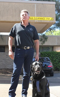 Ben Felten stand outside with his Seeing Eye Dog Orson