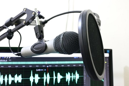 Image shows a microphone and other recording equipment