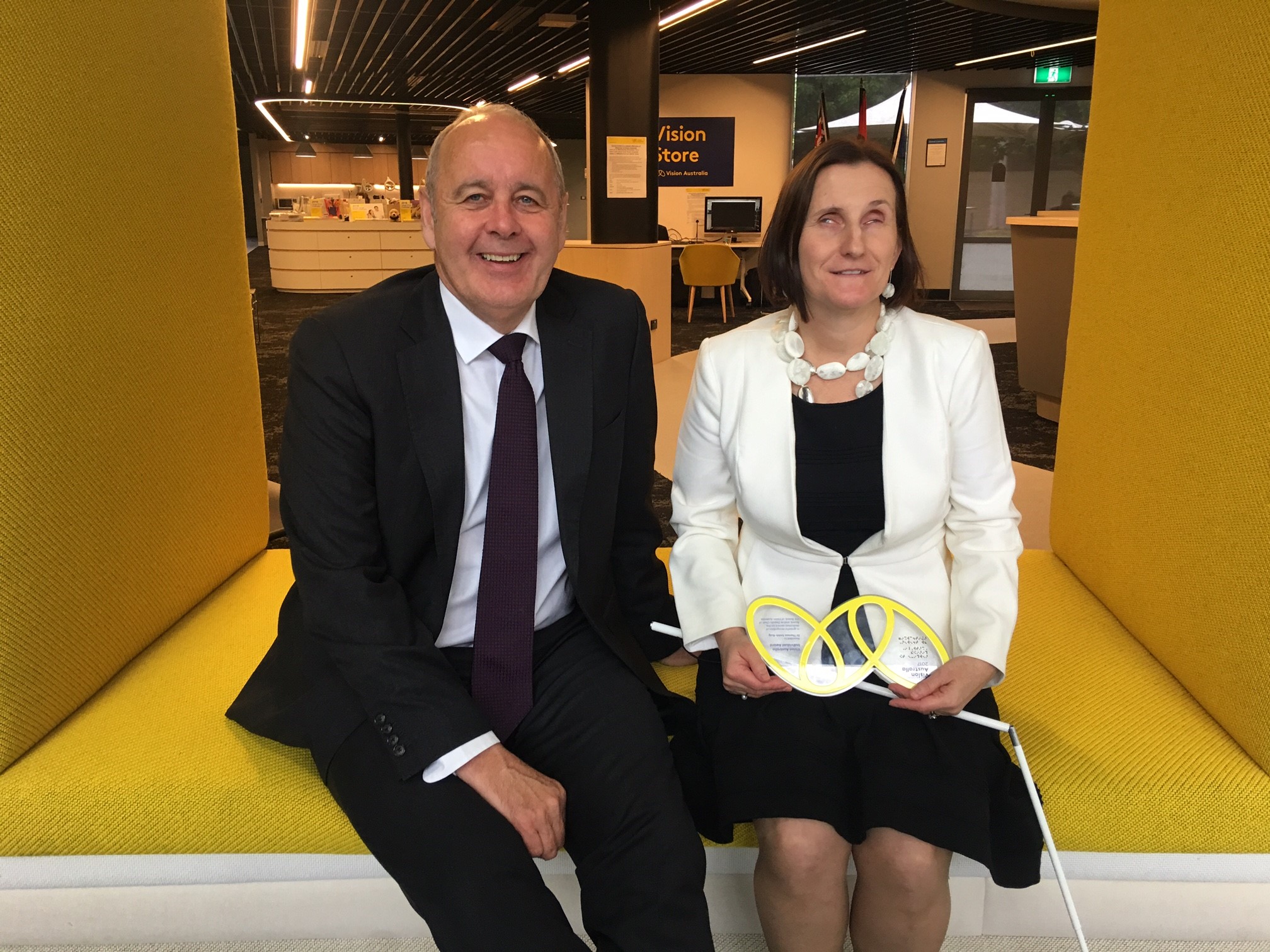 Vision Australia CEO Ron Hooton, left, with Theresa Smith-Ruig and her Vision Australia Award.