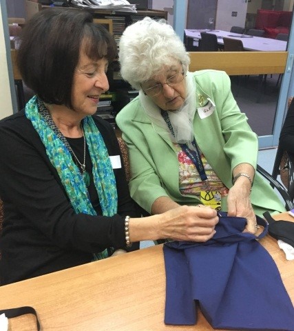 "One of our volunteers helps a client by describing a piece of clothing."