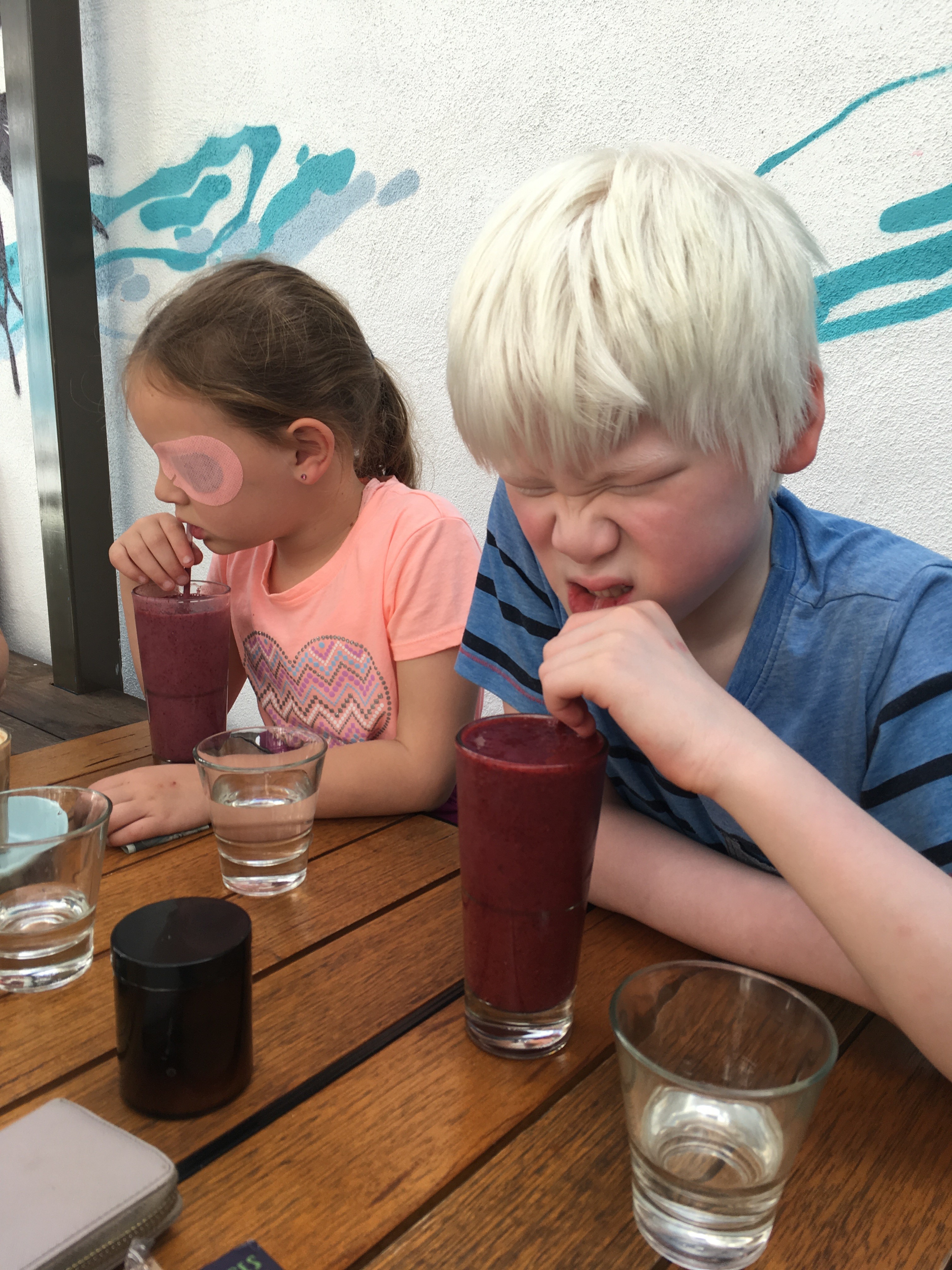 Girl and boy drinking smoothies on a trip to a local cafe