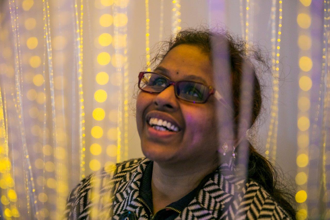 Vision Australia client Sashi pictured in the sensory room smiling