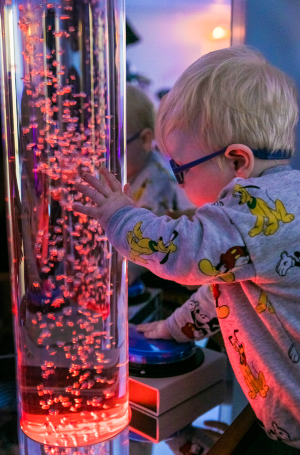Small boy interacting with a display in Vision Australia's Sensory Campus