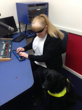 Vision Australia Radio volunteer Vicki Couzens in the Adelaide studios with her dog guide Bella