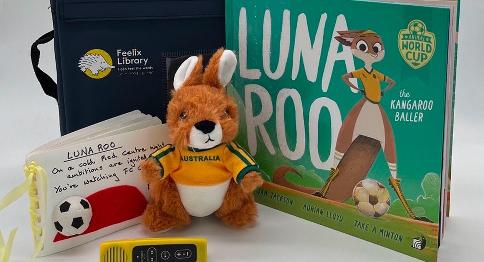 Storybook kit, displaying a plush kangaroo toy, an audio player, storybook "Luna Roo" and a tactile book of the same story.